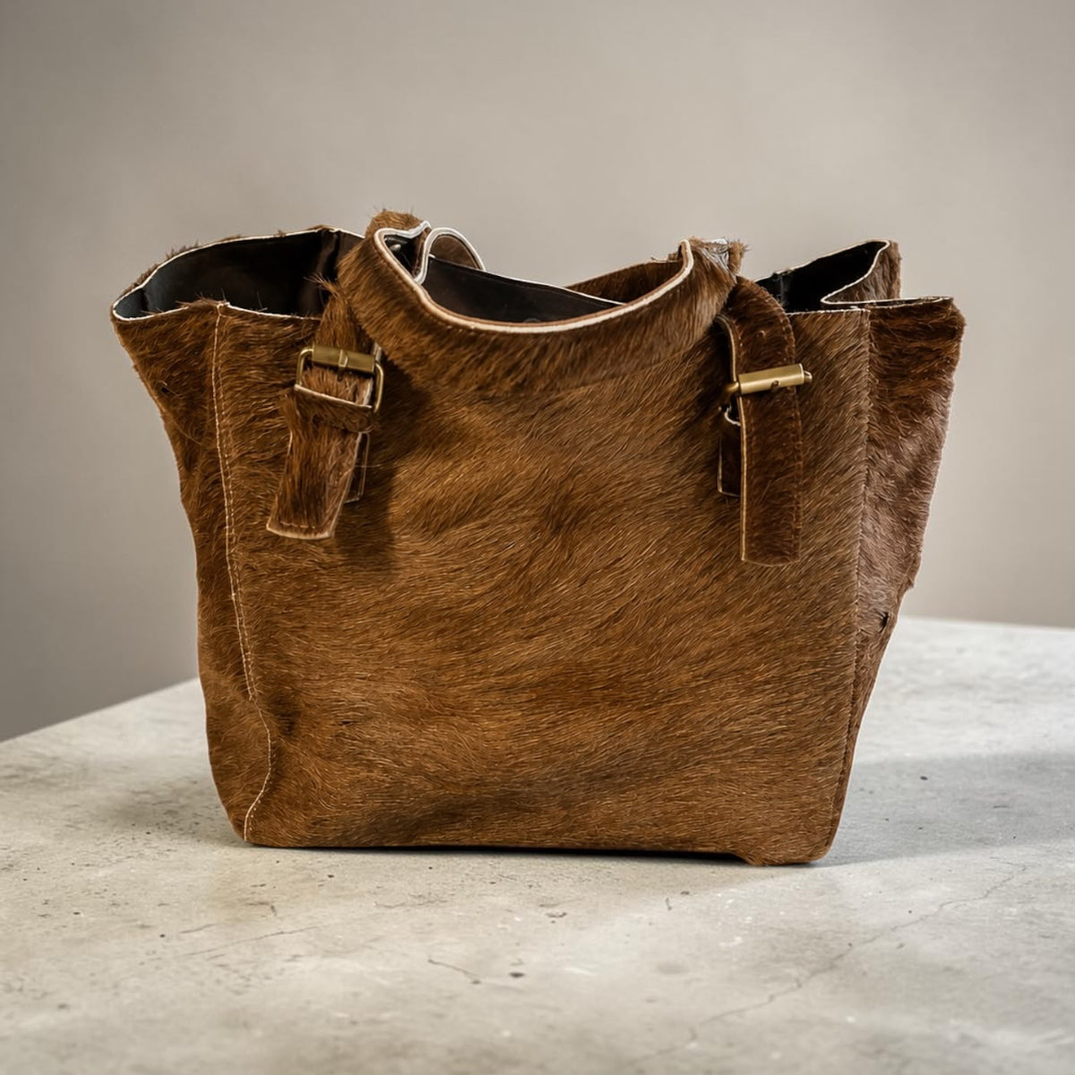 Black brown hair-on genuine cowhide leather tote with leather straps and brass hardware