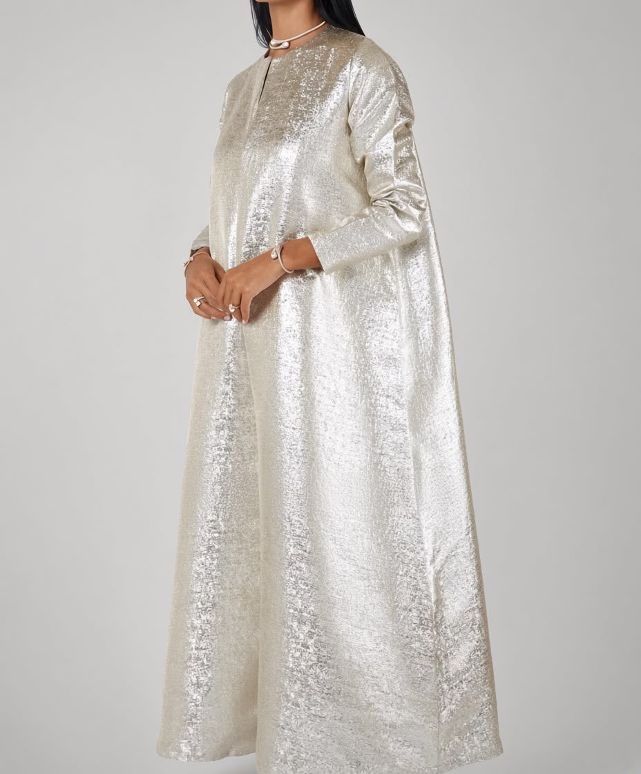 Model wearing a floor-length silver metallic kaftan